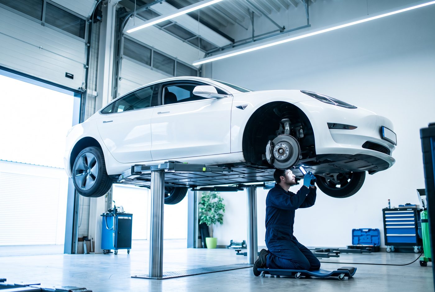 EV on a lift for suspension repair